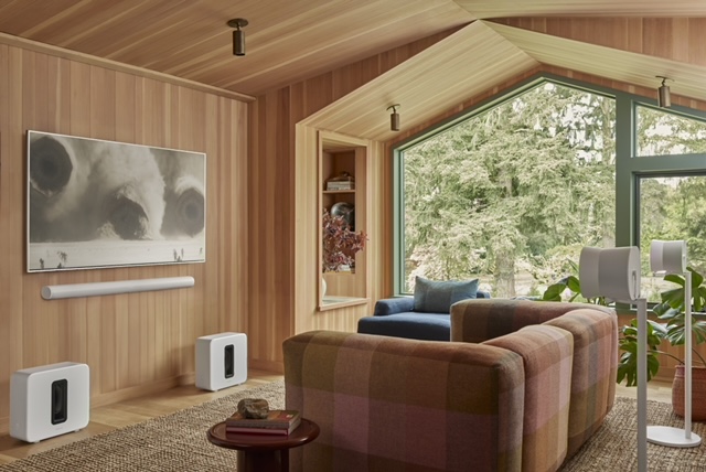A contemporary living room setting with a wall-mounted smart TV and floor speakers