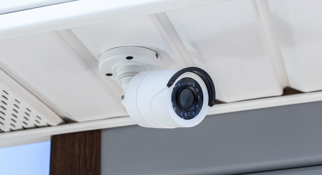A security camera mounted to a soffit